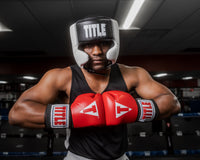 variant:black::TITLE Boxing Aerovent Elite USA Boxing Competition Headgear – With Cheeks man touching gloves