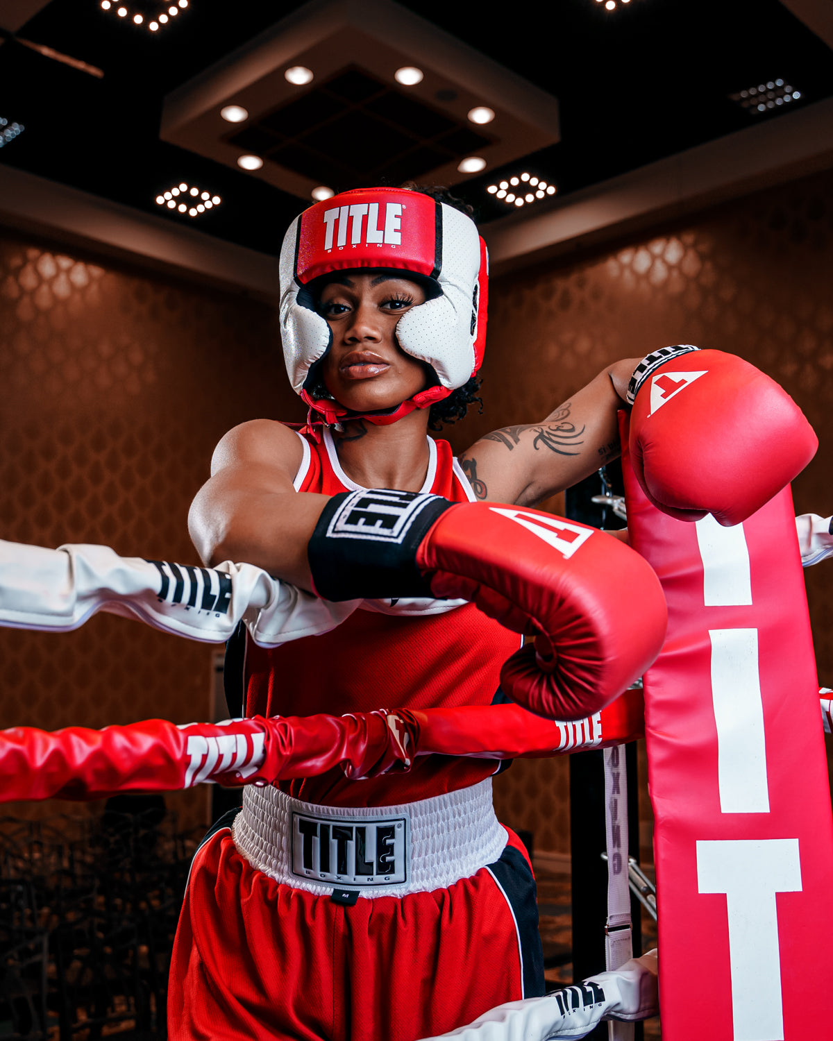 variant:red::TITLE Boxing Aerovent Elite USA Boxing Competition Headgear – With Cheeks woman in a ring
