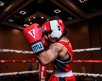 variant:red::TITLE Boxing Aerovent Elite USA Boxing Competition Headgear – With Cheeks women punching stance