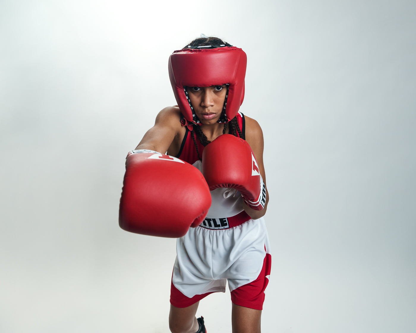 variant:blank red::TITLE Boxing USA Boxing Competition Headgear - Open Face kid throwing right punch 
