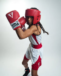 variant:blank red::TITLE Boxing USA Boxing Competition Headgear - Open Face kid punching stance