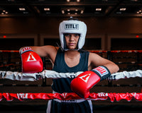 variant:white::TITLE Boxing USA Boxing Competition Headgear - Open Face kid standing in the ring hands on rope