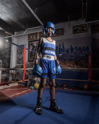 variant:blank blue::TITLE Boxing USA Boxing Competition Headgear - With Cheeks kid standing in ring