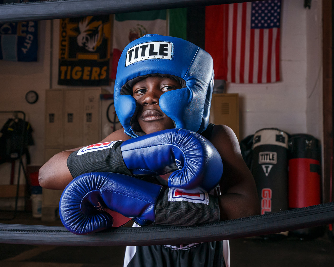 variant:blue::TITLE Boxing USA Boxing Competition Headgear - With Cheeks guy standing on ropes