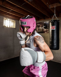 variant:pink::TITLE Boxing USA Boxing Competition Headgear - With Cheeks girl standing in ring