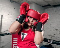 variant:Blank Red::TITLE Boxing USA Boxing Competition Headgear - With Cheeks girl hands on head