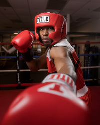 variant:red::TITLE Boxing USA Boxing Competition Headgear - With Cheeks guy throwing left jab
