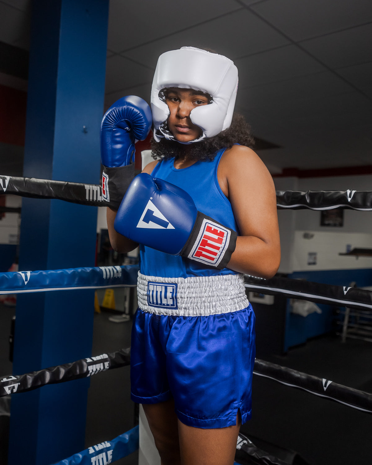 variant:blank white::TITLE Boxing USA Boxing Competition Headgear - With Cheeks girl standing in ring with right hand up