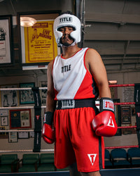 variant:white::TITLE Boxing USA Boxing Competition Headgear - With Cheeks guy standing in ring red gloves