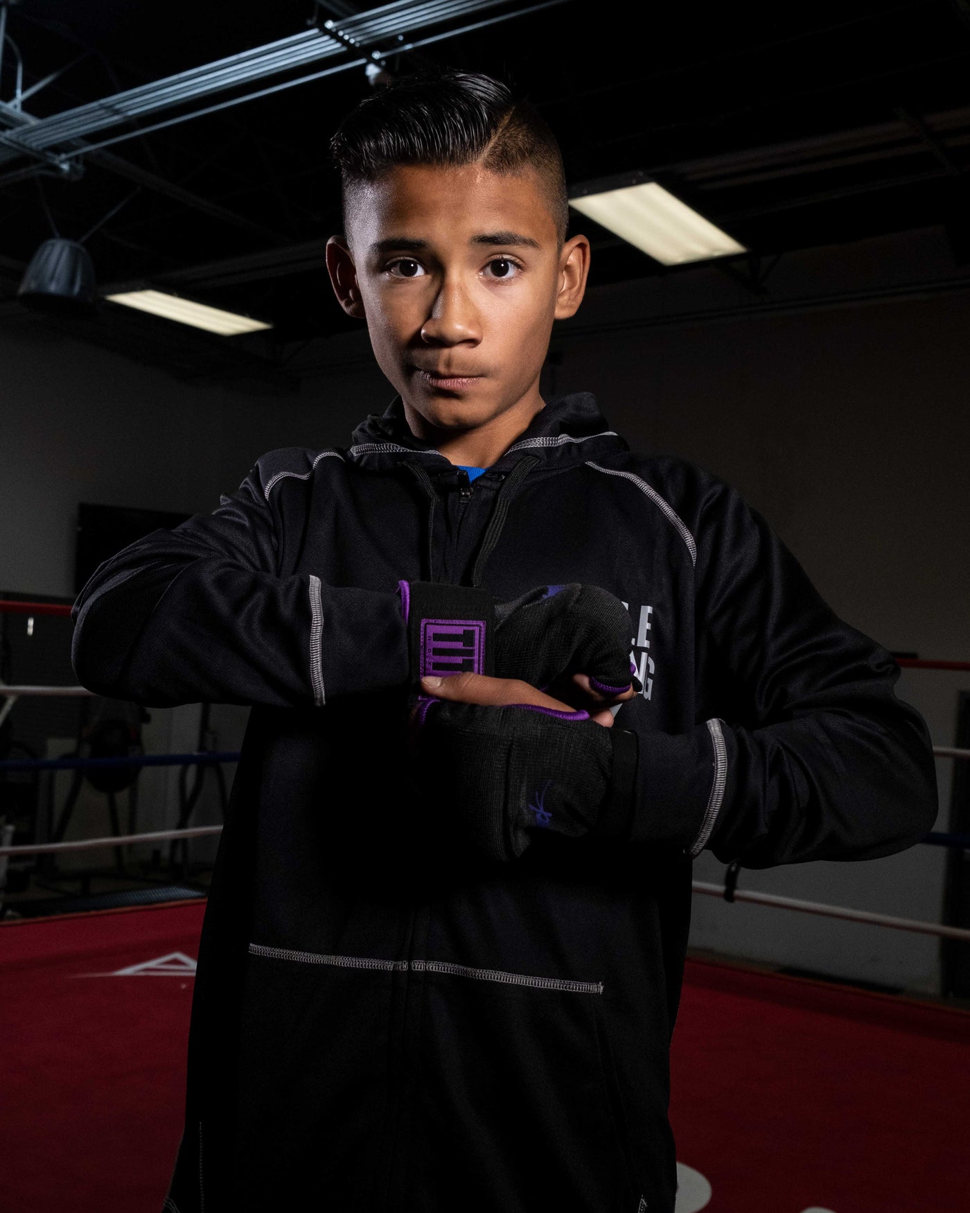 variant:black/purple::TITLE Boxing Attack Nitro Speed Wraps 2.0 kid standing in ring