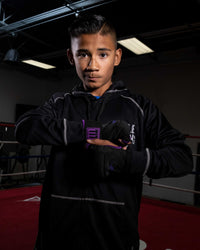 variant:black/purple::TITLE Boxing Attack Nitro Speed Wraps 2.0 kid standing in ring