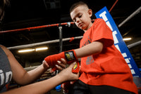variant:red::BOOM BOOM Boxing Youth Flex Hand Wraps kid getting his hands wrapped