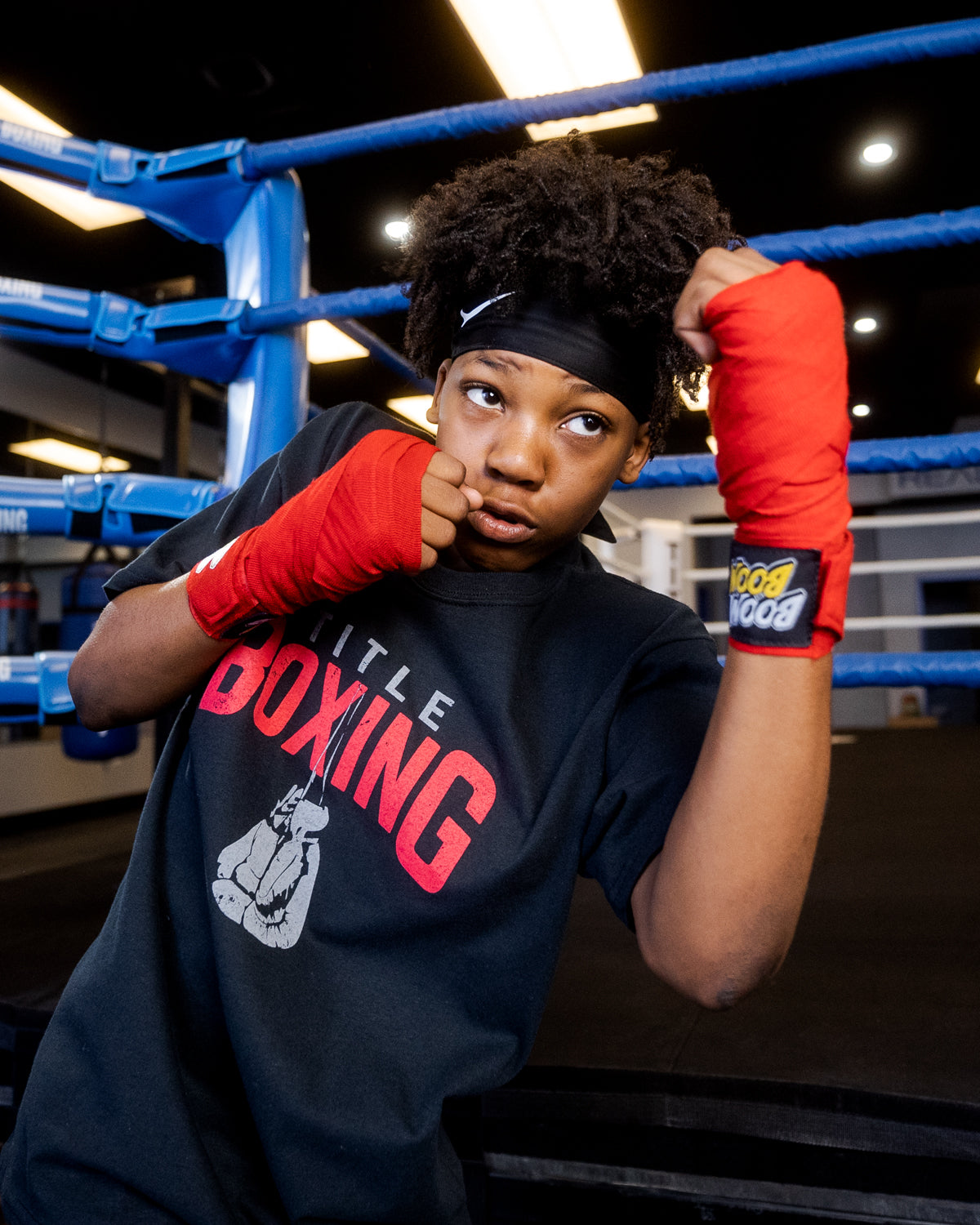 variant:red::BOOM BOOM Boxing Youth Flex Hand Wraps kid throwing left uppercut