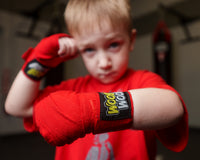 variant:red::BOOM BOOM Boxing Youth Flex Hand Wraps kid close up of one handwrap