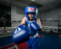 variant:blue::TITLE Classic USA Boxing Competition Headgear – Open Face kid in ring