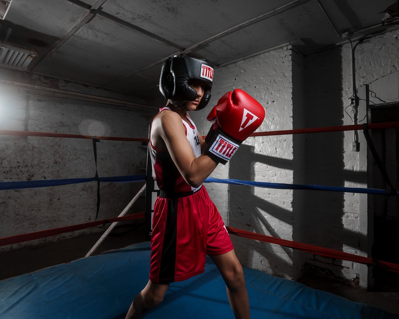 variant:black::TITLE Classic USA Boxing Competition Headgear- With Cheeks kid in ring red gloves