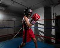 variant:black::TITLE Classic USA Boxing Competition Headgear- With Cheeks kid in ring red gloves