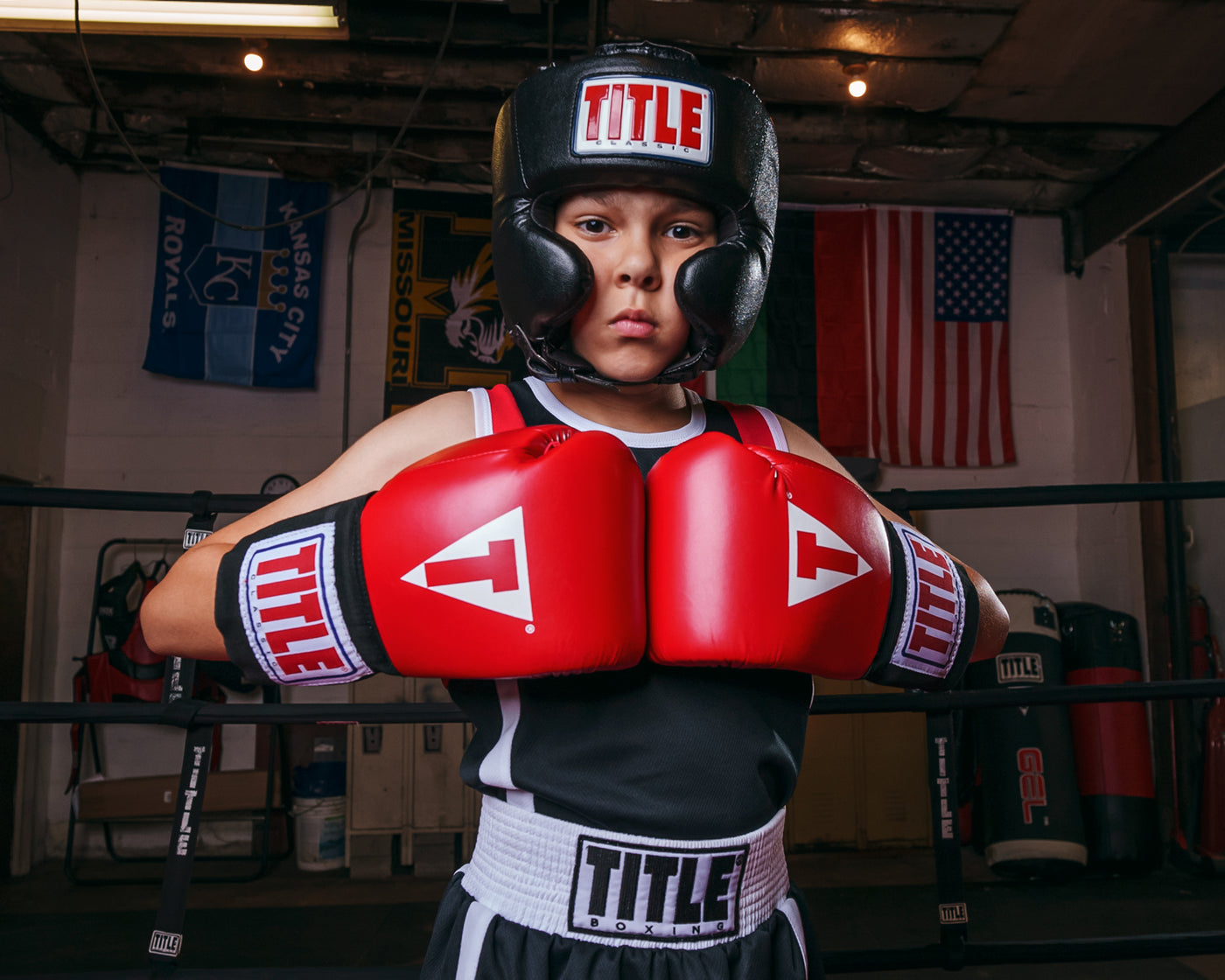 variant:black::TITLE Classic USA Boxing Competition Headgear- With Cheeks kid in ring gloves together