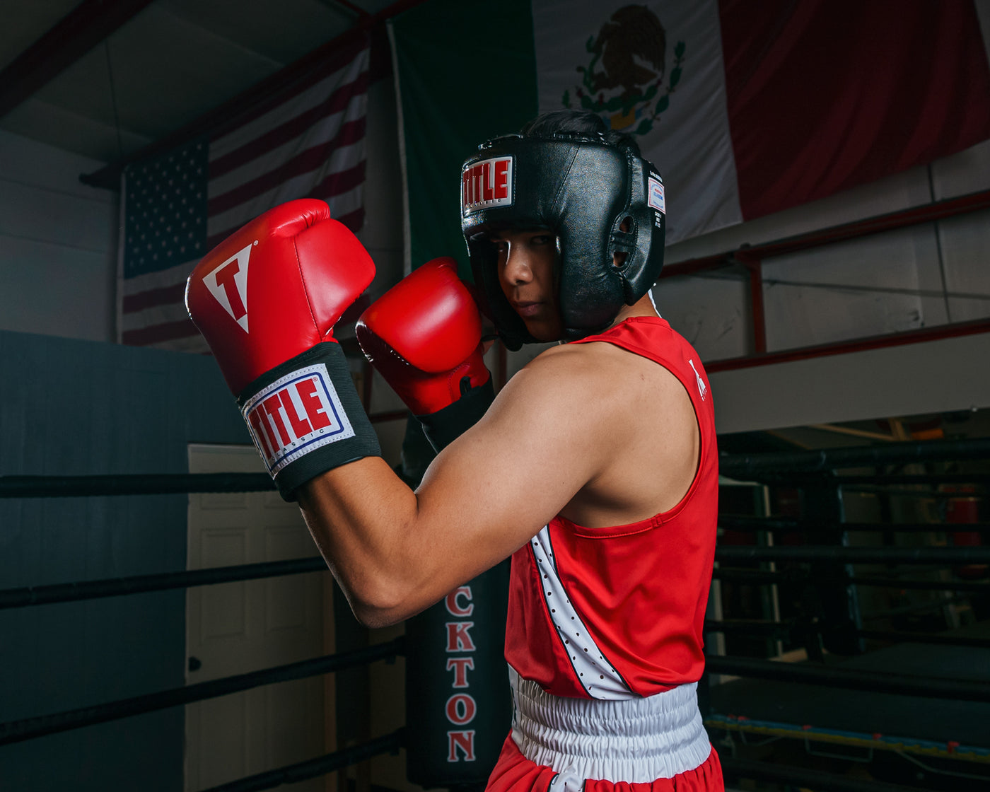 variant:black::TITLE Classic USA Boxing Competition Headgear- With Cheeks  kid in ring boxing stance