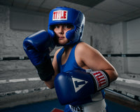 variant:blue::TITLE Classic USA Boxing Competition Headgear – With Cheeks kid in ring boxing pose