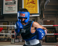 variant:blue::TITLE Classic USA Boxing Competition Headgear – With Cheeks guy in ring black jersey on
