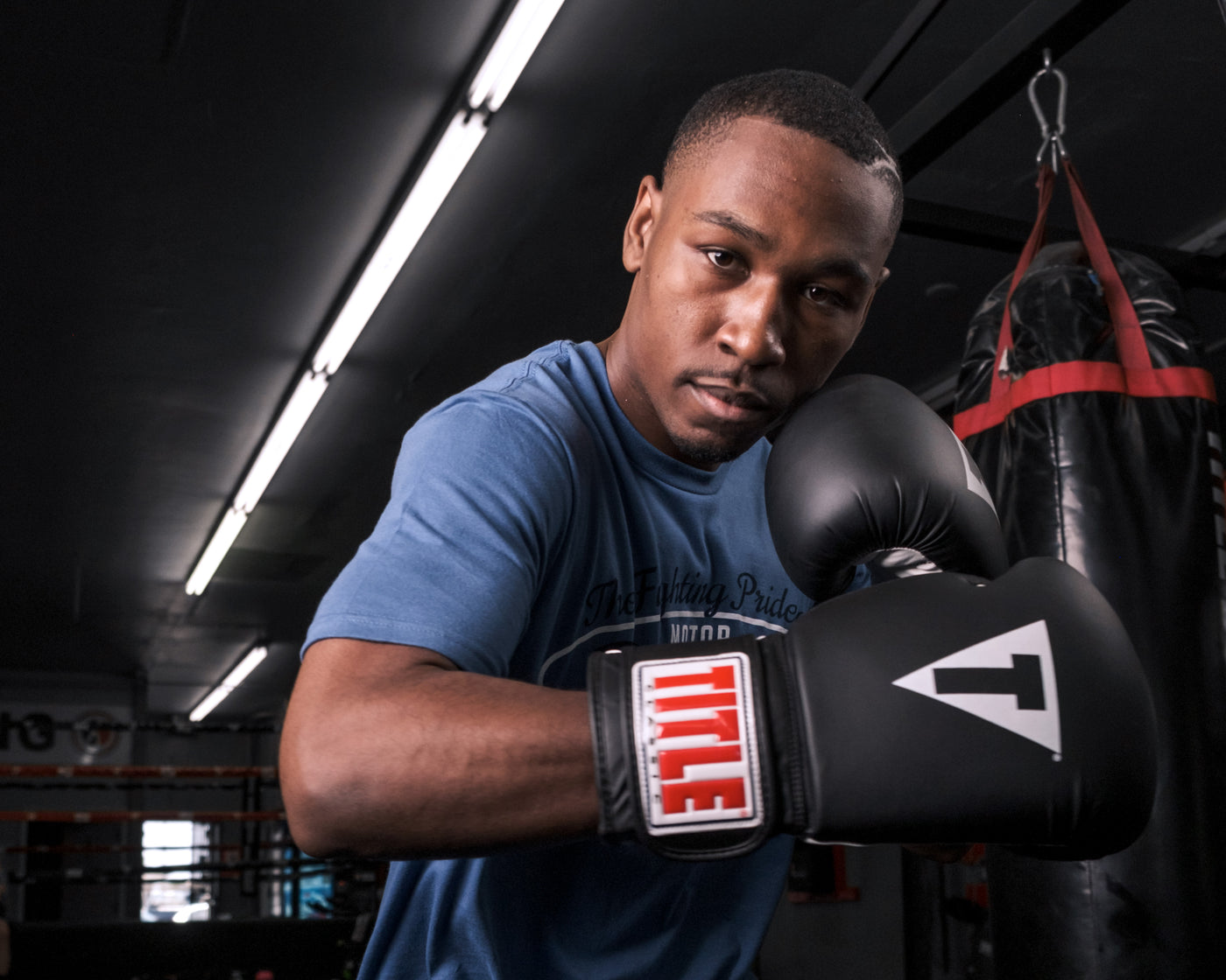 variant:black/white::TITLE Classic Fitness Boxing Gloves guy posing with gloves on 
