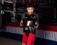 variant:black::TITLE Classic Super Bag Gloves 2.0 kid wearing protective cup and gloves