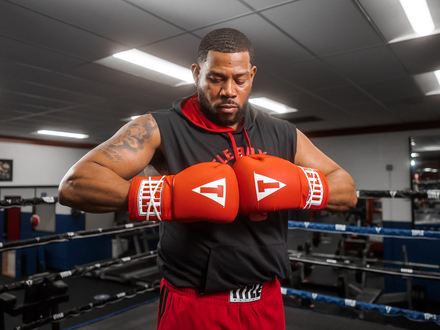 variant:red::TITLE Classic Leather Lace Training Gloves 2.0 guy in ring with hands together 