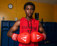 variant:red::TITLE Classic Leather Elastic Training Gloves guy holding gloves together