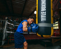 variant:blue/black::TITLE Boxing Dauntless Training Gloves guy hitting bag
