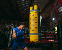 variant:blue/black::TITLE Boxing Dauntless Training Gloves alt guy hitting bag full bag