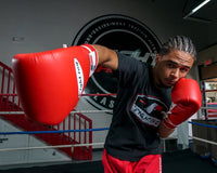 variant:red::Fighting Fury Professional Lace Training Gloves guy punching with boxing gloves