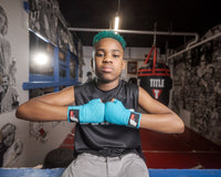 variant:lifestyle::Fighting Sports Gloves and Wraps Bundle turquoise wraps on fighter in the gym