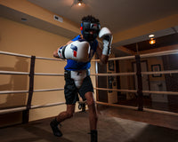 variant:white/blue::Fighting Force Training Gloves guy posing with gloves in ring