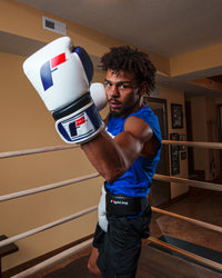 variant:white/blue::Fighting Force Training Gloves guy in ring posing with gloves