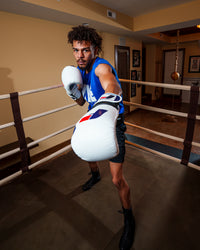 variant:white/blue::Fighting Force Training Gloves guy posing in ring with gloves