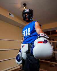 variant:white/blue::Fighting Force Training Gloves guy posing with gloves in ring