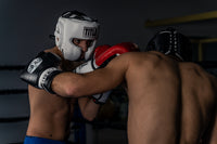 variant:White::TITLE Boxing Leather Sparring Headgear man wearing headgear sparring with another man