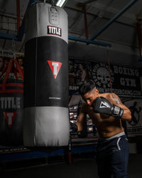 variant:Grey/Black::TITLE Boxing Gel Glory Super Bag Gloves 2.0 man striking bag