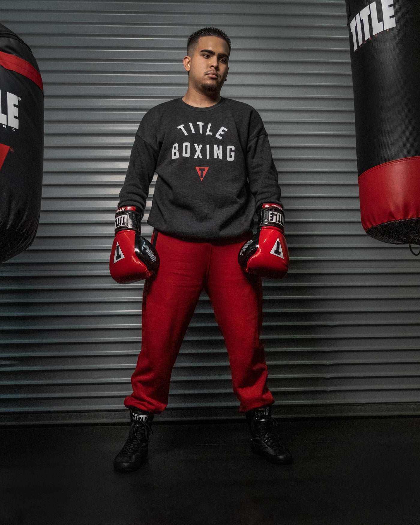 variant:Red/Black::TITLE Boxing Gel Glory Super Bag Gloves 2.0 man posing with gloves