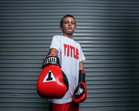 variant:Red/Black::TITLE Boxing Gel Glory Super Bag Gloves 2.0 kid posing with gloves
