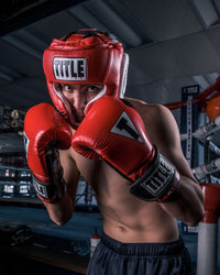 variant:Red::TITLE Boxing Gel World Full Face Training Headgear man posing with headgear
