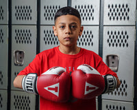 variant:Red::TITLE Boxing Gel World Bag Gloves boy posing with gloves