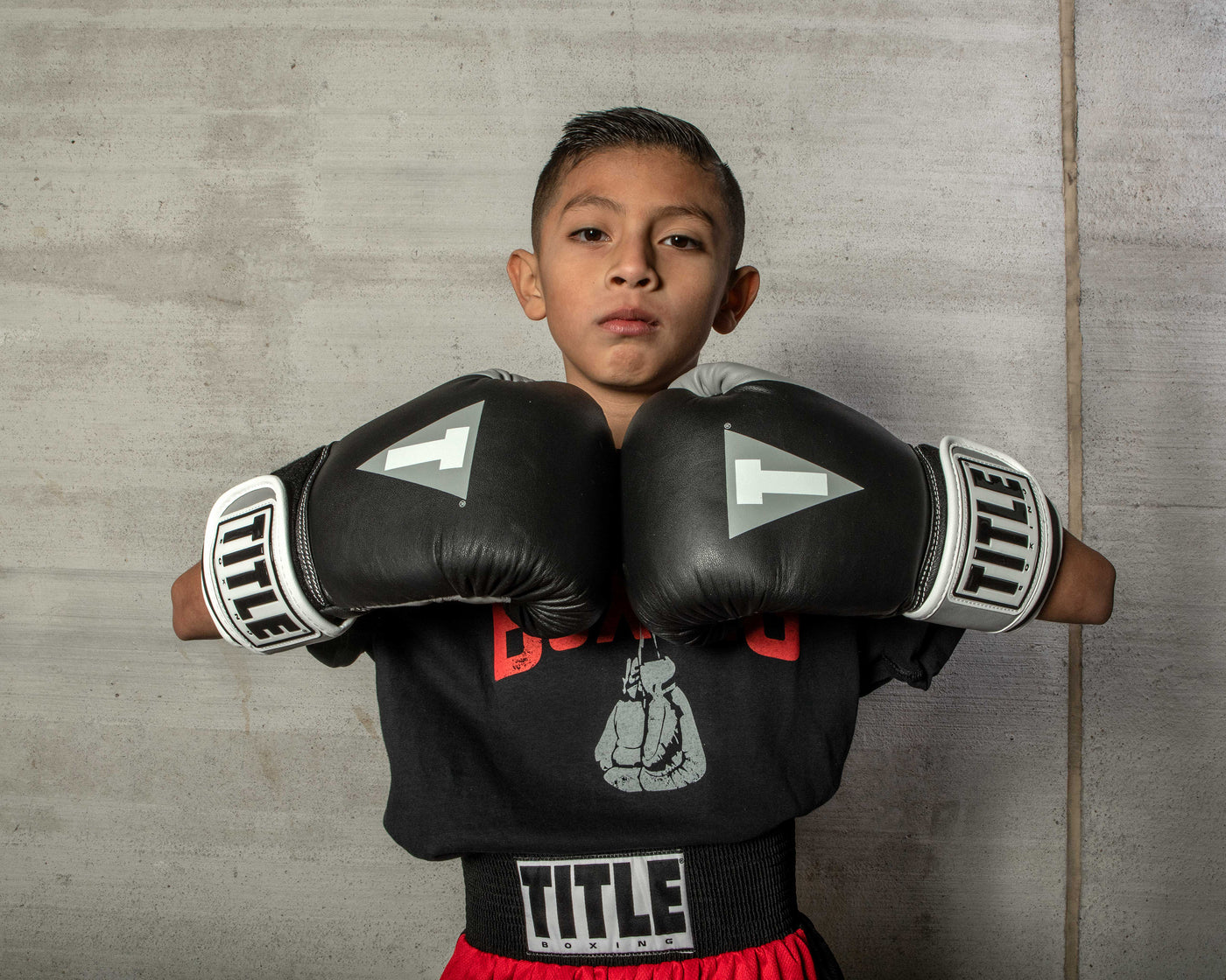 variant:black/silver::TITLE Boxing Gel World V2T Bag Gloves kid posing with boxing gloves
