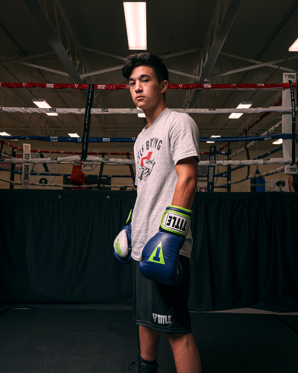 variant:navy/grey::TITLE Boxing Gel World V2T Bag Gloves kid posing with boxing gloves