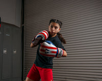 variant:lifestyle::TITLE Boxing Infused Foam Combat USA Training Gloves girl posing with boxing gloves