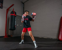 variant:lifestyle::TITLE Boxing Infused Foam Combat USA Training Gloves girl posing with boxing gloves