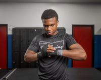 variant:black::TITLE Boxing Traditional Weave 180" Hand Wraps guy with hands wrapped in hand wraps