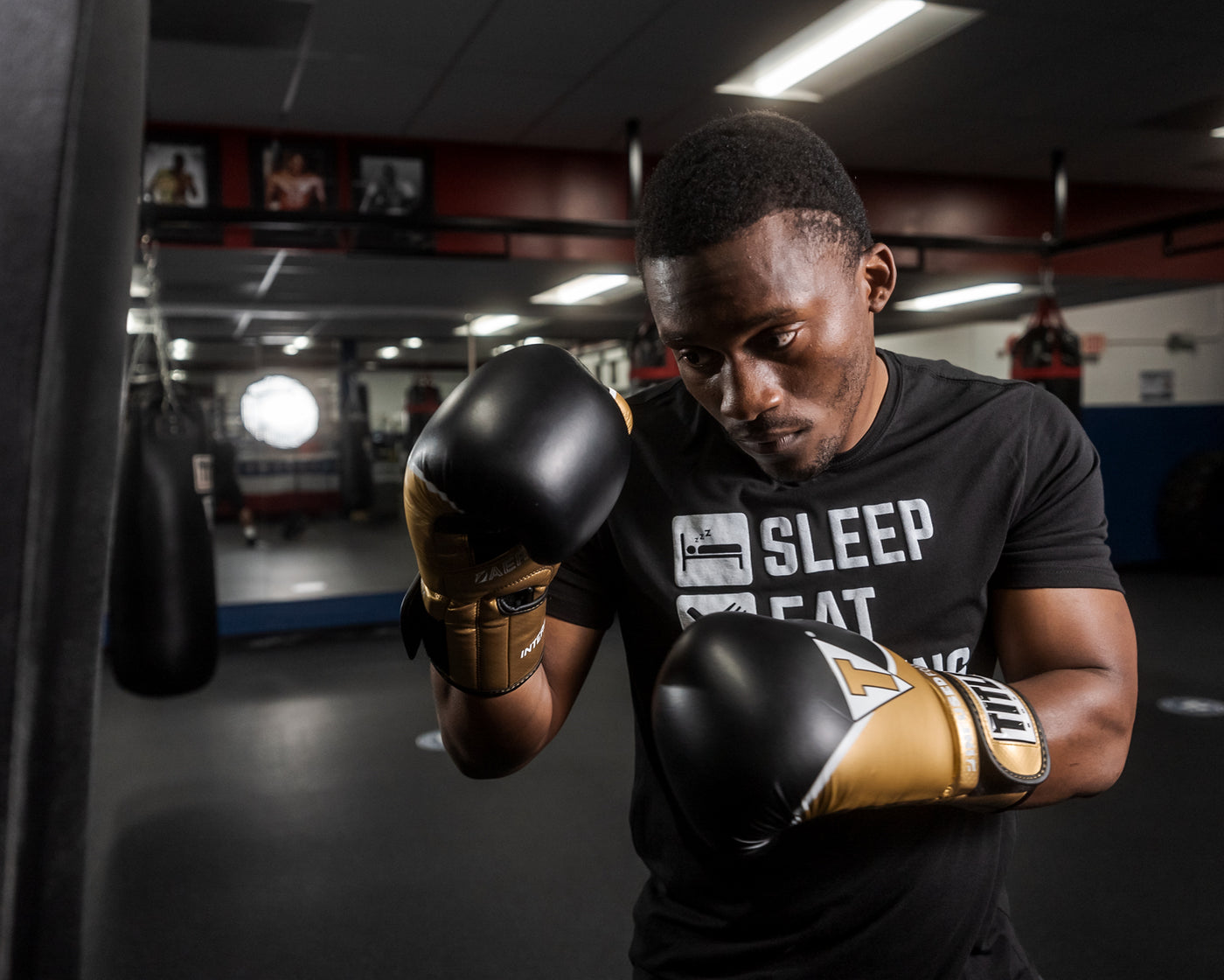 variant:gold/black::TITLE Boxing Infused Foam Interrogate Training Gloves 2.0 guy posing with boxing gloves