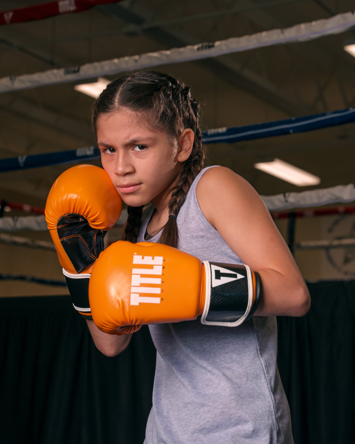 variant:orange/black::TITLE Boxing Instinct Fitness Bag Gloves girl posing with boxing gloves